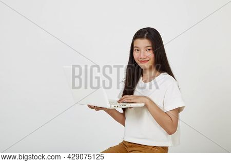 Woman With Laptop Computer Sitting Cross Legged And Looking