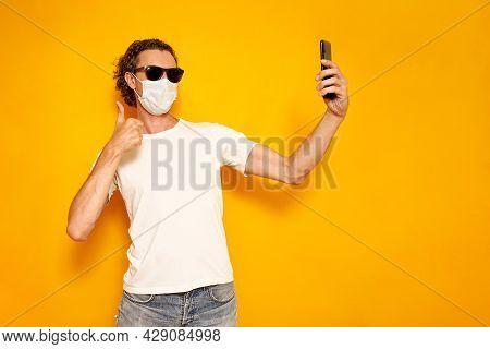 Male Blogger Takes Selfie, Communicates Via Video Communication With Subscribers Via Phone In White 