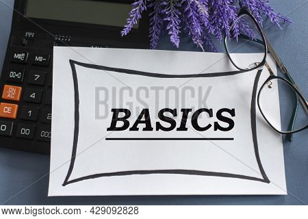 Basics - Word On A White Sheet Against The Background Of Glasses, Pens And Lavender. Business Concep