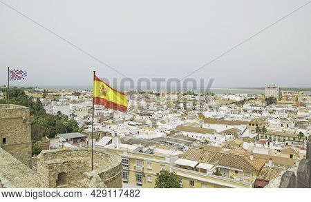Views Of The Town Of Sanlucar De Barrameda From The Top Of The Castle With A Spanish Flag Flying Fro