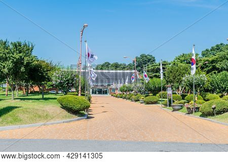 Yesan-gun, South Korea; July 30, 2021: Flag Lined Sidewalk Leading To Yun Bong-gil Memorial Hall.