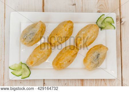 Top View Of Japanese Inari-zushi With Rice And Tofu Served On A White Plate