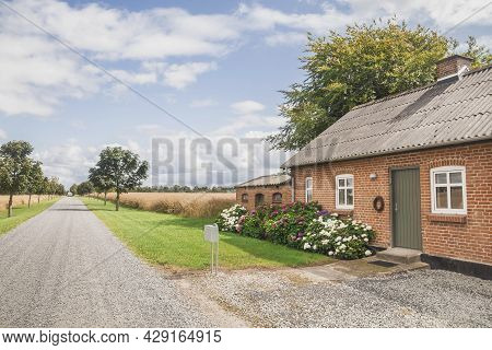 Skals, Denmark, July 2021: Beautiful Farmhouse Near The Field