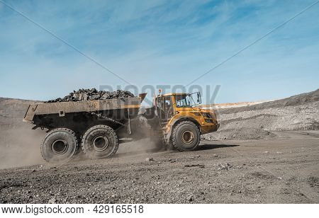 Large Quarry Dump Truck. Loading The Rock In Dumper. Loading Coal Into Body Truck. Production Useful