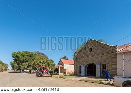 Rouxville, South Africa - April 23, 2021: A Street Scene, With Old Buildings, People And A Frontload