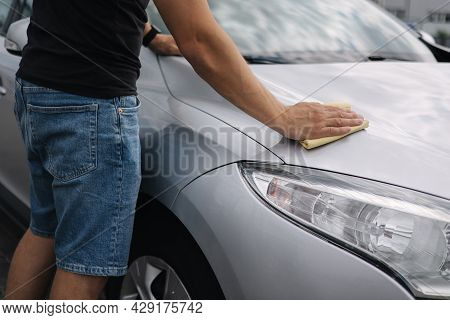 Middle Selection Of Handsome Man Wipes A Car With A Rag In A Showroom At A Self-service Car Wash. Gr