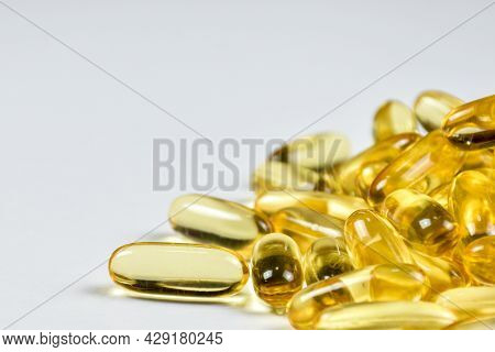 Cloae Up Of Fish Oil Capsules Gel On White Background View With Copy Space. Salmon Fish Capsule Gels