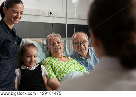 Physician Doctor Checking Sick Senior Woman Discussing Healthcare Treatment During Clincal Therapy. 
