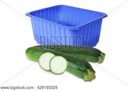 Blue Plastic Box And Zucchini Isolated In White. Blue Plastic Container And Zucchini