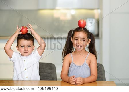 Little Funny Cute Children Laughing With Apple On Head.