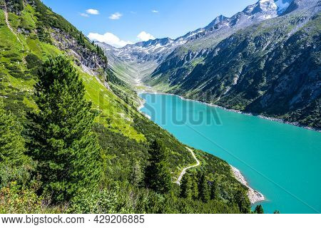 Vivid Blue Mountain Lake In Summer Alps. Speicher Zillergrundl Dam, Zillertal Alps, Austria
