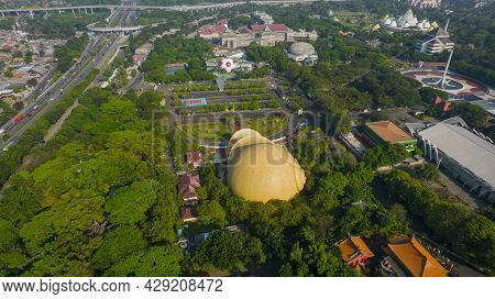 Aerial View Of Keong Mas Teater, Taman Mini Indonesia Indah Or Tmii With Noise Cloud. Jakarta, Indon