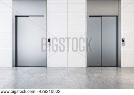 Modern Office Lobby Interior With Steel Elevators, Concrete Flooring And Tile Wall. 3d Rendering
