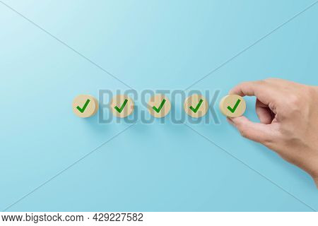 Checklist And Check Mark Concept. Check Mark On Wooden Blocks On Light Blue Background
