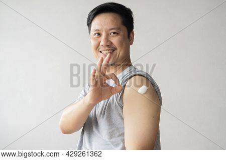 Healthy Asian Man Getting Vaccinated Immunity Giving Ok Hand Sign To Rolling Out Vaccine, Concept Of