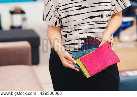 Woman Chooses The Colors And Patterns Of Upholstery Fabrics. Textile Industry Background. Tissue Cat