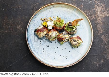 Unagi Ebi Ten Roll, Top View. 6 Piece Sushi Set With Eel, Shrimp In Tempura, Cucumber, Oshinko, Garn