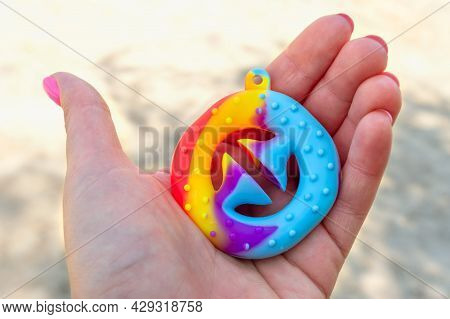 Snapperz - Colorful Rubber Antistress Toy Expander In The Hand. Close-up.