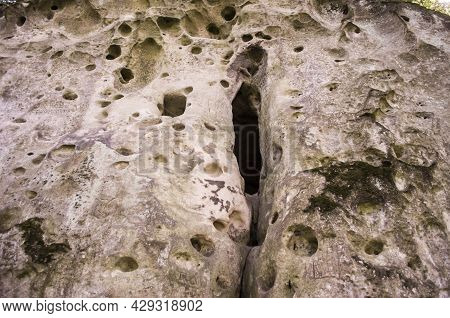Entrance To The Limestone Cave In The Form Of A Vulva. Natural Nature Photo.