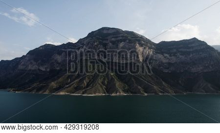 Aerial View Of A Calm Lake Water Surface Of A Turquoise Color. Action. Breathtaking Summer Scenery W