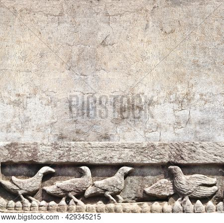 Retro background with ancient wall carving with birds. Vertical banner with stone bas-relief depicting birds, khmer culture, Angkor, Cambodia. Mock up template. Copy space for text