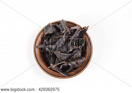 Dried Dog Treats In A Brown Clay Bowl On A White Background. Thin Slices Of Dehydrated Beef Heart. T