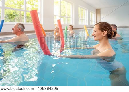 Patients during remobilization in a health center doing aquarobics