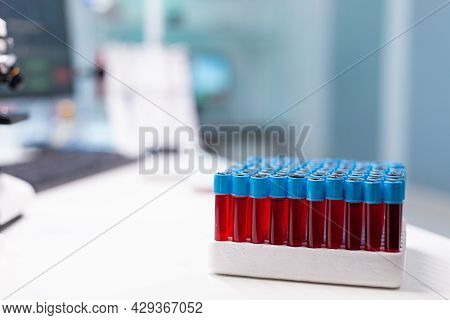 Medical Vacutainer With Blood Sample Standing On Table During Pharmaceutical Examination In Microbio