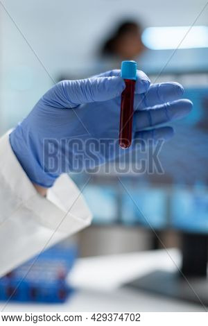 Closeup Of Biologist Researcher Man Holding Medical Vacutainer With Blood Sample Examining Dna Durin