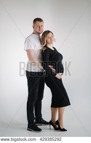 Happy Future Parents Of Man And Pregnant Woman Puts Hands On Belly And Waiting For Beby Movement In 