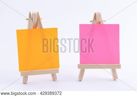 Two Wooden Easels Miniature With Blank Colored Square Canvas Or Memo Paper - Mockup. Mini Wooden Sta