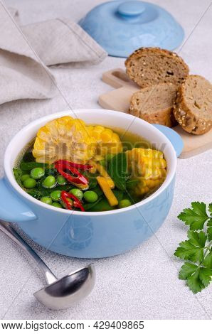 Vegetable Transparent Soup In A Ceramic Dish On A Cement Background. Selective Focus.