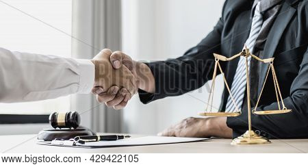 Lawyer And Client Shake Hands, After Winning A Lawsuit Where A Lawyer Hired By A Client In A Fraud C