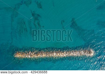 Aerial View From A Flying Drone Of Blue Sea Water And Breakwater. Sea Wall Paphos Cyprus