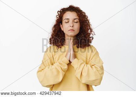 Calm Young Redhead Woman, Mindful Girl Meditating, Showing Namaste Buddha Gesture With Realxed Resti