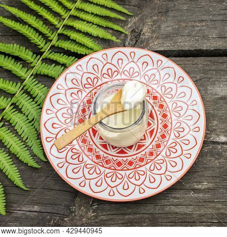 Eco Friendly, Food Composition With Organic, Vegan, Homemade Yogurt With Wooden Spoon And Fern Leave