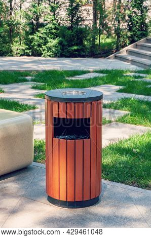 Metallic Trash Bin On The Street, Outdoors. Stainless Steel Litter Bin With Wood Paneling, With A As