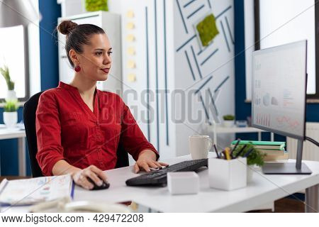 Woman Entrepreneur Working On Financial Expertise From Company Office. Looking At Charts And Graphs 