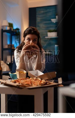 Portrait Of Woman Holding Delicious Buger Eating Takeaway Delivery Food Watching Entertainment Movie