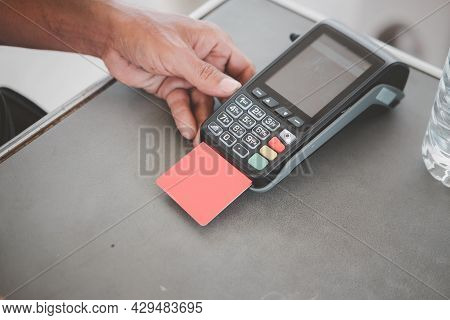 Man Put The Red Credit Card Into A Reader, Close Up