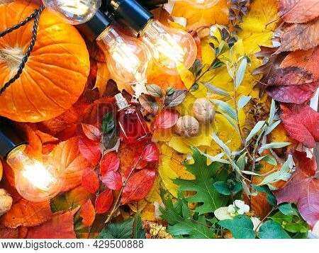 Unbranded Red Perfume Bottle, Pumpkin And Magic Lights On Autumn Bright Colorful Leaves. Fall Flatla