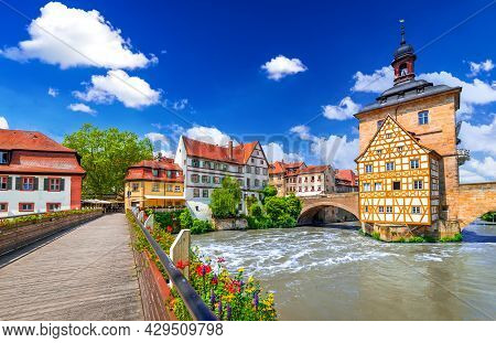 Bamberg, Germany. Half-timbered Town Hall And Regnitz River, Old Buildings And Bridge Decorated By F