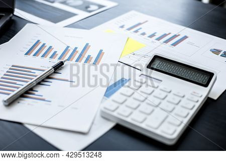 Businessman's Desk The Sales Manager's Desk Has A White Sheet Of Monthly Sales Data, A Salesperson,