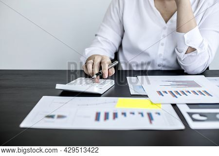 A Businesswoman Is Pressing A White Calculator, She Is Calculating The Numbers On The Company Financ