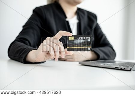 A Business Woman Holds A Credit Card To Make Payments On The Website Where She Is Shopping Online. C