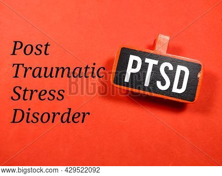 Business Concept.text Ptsd Writing On Colored Wooden Board On A Red Background.