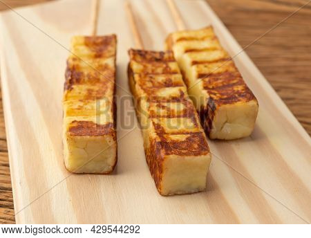 Grilled Rennet Or Coalho Cheese On A Wooden Board.