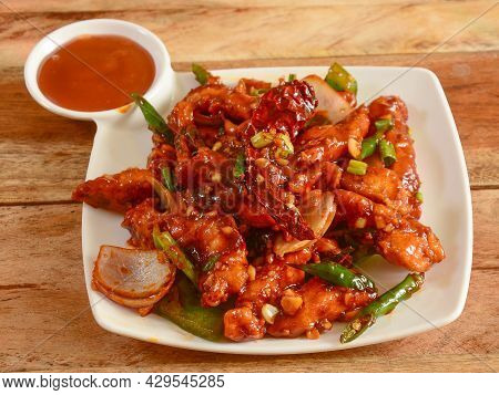 Assorted Indian Food Honey Chilli Chicken On Wooden Background. Dishes And Appetizers Of Indian Cuis