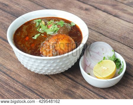 Anda Masala Or Egg Curry Is Popular Indian Spicy Food, Served In A Ceramic Bowl Over Rustic Wooden B