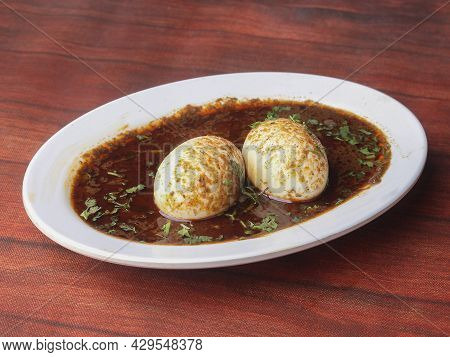 Anda Masala Or Egg Curry Is Popular Indian Spicy Food, Served In A Ceramic Bowl Over Rustic Wooden B